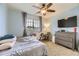 Comfortable bedroom with a ceiling fan, desk, and carpet flooring, offering a cozy and functional space at 26072 E Fremont Pl, Aurora, CO 80016