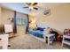 This is a bedroom with a ceiling fan, carpet flooring, toys, and a bed with storage space at 26072 E Fremont Pl, Aurora, CO 80016