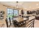 Inviting dining area features a wood table, a modern light fixture, and sliding glass doors to the outside at 26072 E Fremont Pl, Aurora, CO 80016