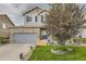 Charming two-story home with a brick facade, well-maintained lawn, and mature landscaping at 26072 E Fremont Pl, Aurora, CO 80016