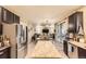 Spacious kitchen offering stainless steel appliances, island and dark cabinets with an open layout at 26072 E Fremont Pl, Aurora, CO 80016