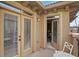 Inviting outdoor balcony with a bistro table and chairs, accessible through double doors at 7651 E 26Th Ave, Denver, CO 80238