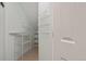 Well-organized closet features multiple shelves and racks for ample storage, maximizing space at 7651 E 26Th Ave, Denver, CO 80238