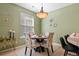 Bright dining room features a round table with 4 cushioned chairs and decorative light fixture at 7651 E 26Th Ave, Denver, CO 80238