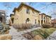 Two-story stucco home featuring arched windows, concrete walkway, and a landscaped yard at 7651 E 26Th Ave, Denver, CO 80238