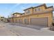 A row of townhomes with private garages, showcasing modern architecture and design at 7651 E 26Th Ave, Denver, CO 80238