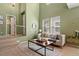 Cozy living room showcasing a modern couch, decor, and large windows for natural light at 7651 E 26Th Ave, Denver, CO 80238