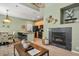 Spacious living room featuring a fireplace, adjacent dining area and open floor plan at 7651 E 26Th Ave, Denver, CO 80238