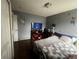 Cozy bedroom with dark hardwood floors, neutral-colored walls, and television at 5129 Chandler Way, Denver, CO 80239