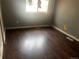 This bedroom features hardwood floors, a window, and gray painted walls at 5129 Chandler Way, Denver, CO 80239