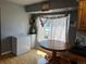 Cozy breakfast nook featuring a round wooden table and a sunny window at 5129 Chandler Way, Denver, CO 80239