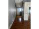 Hallway with hardwood floors, white doors and neutral walls at 5129 Chandler Way, Denver, CO 80239