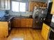 Bright kitchen featuring wood cabinets, stainless steel refrigerator, and dark counters at 5129 Chandler Way, Denver, CO 80239