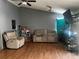 Living room with reclining chairs, laminate floors, and bright natural light at 5129 Chandler Way, Denver, CO 80239