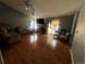 Inviting living room showcasing hardwood floors, comfortable sofas, and a stone fireplace at 5129 Chandler Way, Denver, CO 80239