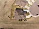 Aerial view of the property showcasing the layout of the house, fence line, long driveway, and landscaping at 16406 W 85Th Ln # A, Arvada, CO 80007