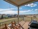 Relaxing back porch featuring a gas grill, wooden chairs, and sweeping mountain views at 16406 W 85Th Ln # A, Arvada, CO 80007