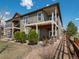Exterior elevation showing the back of the home with a private patio and balcony overlooking the landscaped backyard at 16406 W 85Th Ln # A, Arvada, CO 80007