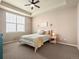 Charming bedroom featuring a ceiling fan, tray ceiling and bright window at 16406 W 85Th Ln # A, Arvada, CO 80007