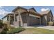 Charming home with a stone and siding exterior and a two-car garage at 16406 W 85Th Ln # A, Arvada, CO 80007