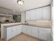 Basement kitchenette featuring bright white cabinets and stainless steel sink at 16406 W 85Th Ln # A, Arvada, CO 80007