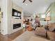 Open-concept living area with a modern fireplace, hardwood floors, and lots of natural light at 16406 W 85Th Ln # A, Arvada, CO 80007