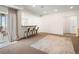 Finished basement living room area with view to a bar and walk out patio at 16406 W 85Th Ln # A, Arvada, CO 80007