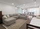 Spacious basement living room featuring a large sectional couch, bar, and small bed at 16406 W 85Th Ln # A, Arvada, CO 80007