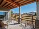 Relaxing covered patio with stone accents and a view of the community's open space and the beautiful Colorado sky at 16406 W 85Th Ln # A, Arvada, CO 80007
