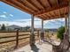 Cozy covered patio area with an open view of the beautiful neighborhood and mountain range in the distance at 16406 W 85Th Ln # A, Arvada, CO 80007