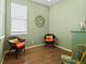 Inviting sitting area with hardwood floors and decoratively painted green walls at 16406 W 85Th Ln # A, Arvada, CO 80007