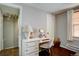 Bright bedroom featuring a white desk, hardwood floor, and a large window at 2870 Jasmine St, Denver, CO 80207