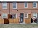 Brick building with private patios, showcasing the exterior of the townhome units at 2870 Jasmine St, Denver, CO 80207