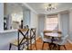Dining area with hardwood floors, adjacent kitchen, and modern lighting at 2870 Jasmine St, Denver, CO 80207