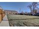 Exterior view of townhomes with a spacious lawn, showcasing a well-maintained community at 2870 Jasmine St, Denver, CO 80207