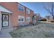 Charming brick home with well-maintained lawn, seating area, and inviting entrance at 2870 Jasmine St, Denver, CO 80207
