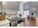 Kitchen cooktop features stainless steel oven and view into the living room at 2870 Jasmine St, Denver, CO 80207