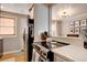 Bright kitchen featuring a stainless steel stove top, white countertop and open layout with natural light at 2870 Jasmine St, Denver, CO 80207