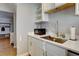 Well-lit kitchen features stainless steel sink, modern appliances, and white cabinets at 2870 Jasmine St, Denver, CO 80207