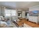 Comfortable living room with hardwood floors, large window, and stylish furnishings at 2870 Jasmine St, Denver, CO 80207