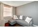 This living room features a gray sofa, hardwood floor, and a large window at 2870 Jasmine St, Denver, CO 80207