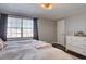 Bright main bedroom with neutral walls, and a view into an ensuite bathroom at 2870 Jasmine St, Denver, CO 80207
