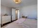 Bright main bedroom with neutral walls, hardwood floor, and a view into an ensuite bathroom at 2870 Jasmine St, Denver, CO 80207