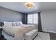 Bright main bedroom with a decorative ceiling light, neutral walls, and a large window at 2870 Jasmine St, Denver, CO 80207