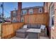 Comfortable outdoor patio featuring stylish seating, privacy fence and a charming gas fire pit at 2870 Jasmine St, Denver, CO 80207