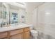 Bathroom featuring a single sink vanity, large mirror, and a shower and bathtub combo at 604 S Yarrow St, Lakewood, CO 80226