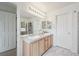Bathroom featuring a double vanity, large mirror, tile floors and a glass door shower at 604 S Yarrow St, Lakewood, CO 80226