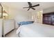 Bright bedroom with wooden bookcase, neutral carpet, white walls and ceiling fan at 604 S Yarrow St, Lakewood, CO 80226