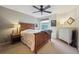 Cozy bedroom with wood-framed bed, ceiling fan, neutral carpet and white dresser at 604 S Yarrow St, Lakewood, CO 80226