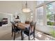 Open-concept dining area with modern lighting, adjacent to a versatile living space with natural light at 604 S Yarrow St, Lakewood, CO 80226